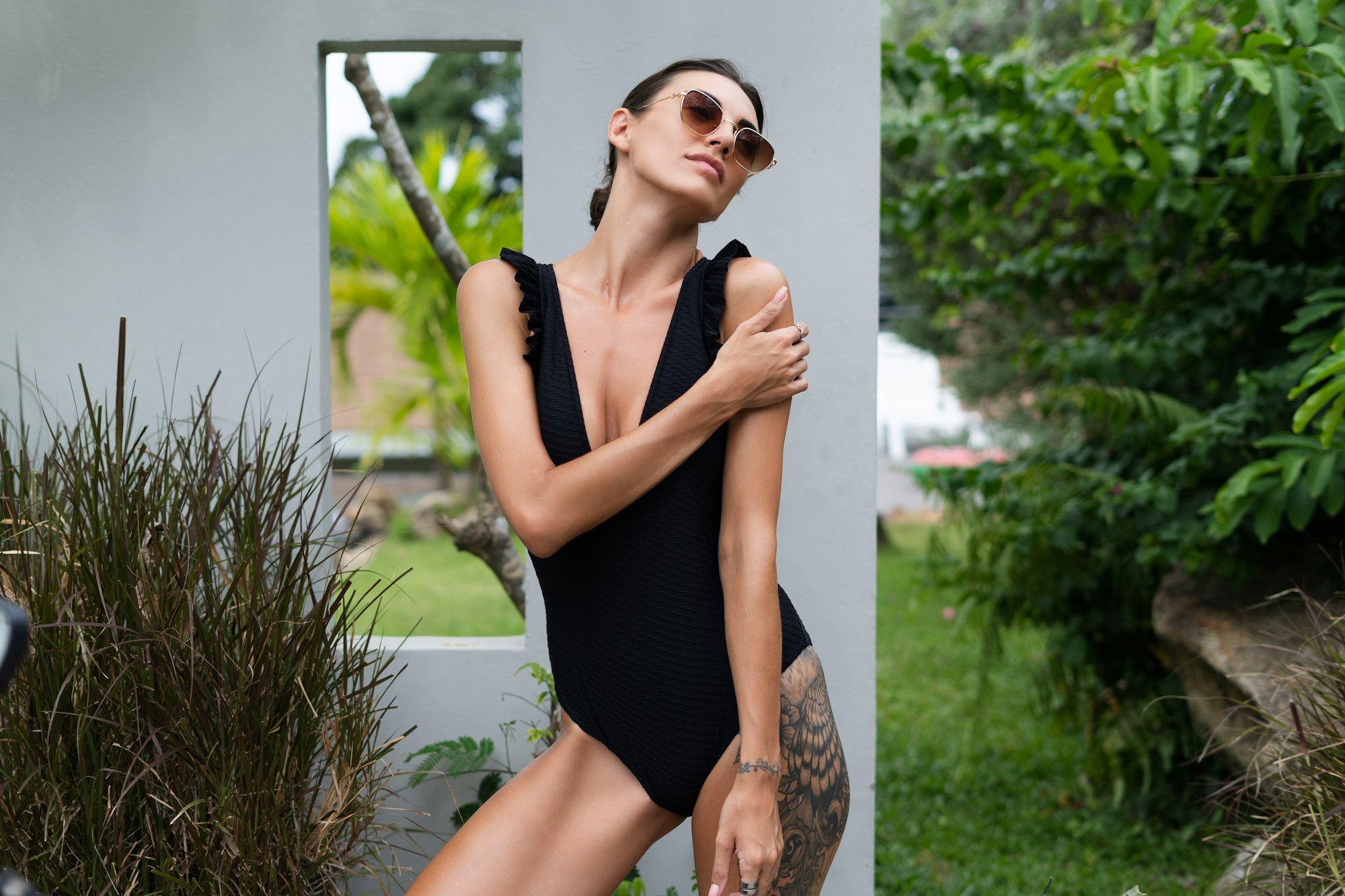beautiful-european-woman-in-black-swimsuit-posing-outside-at-villa.jpg